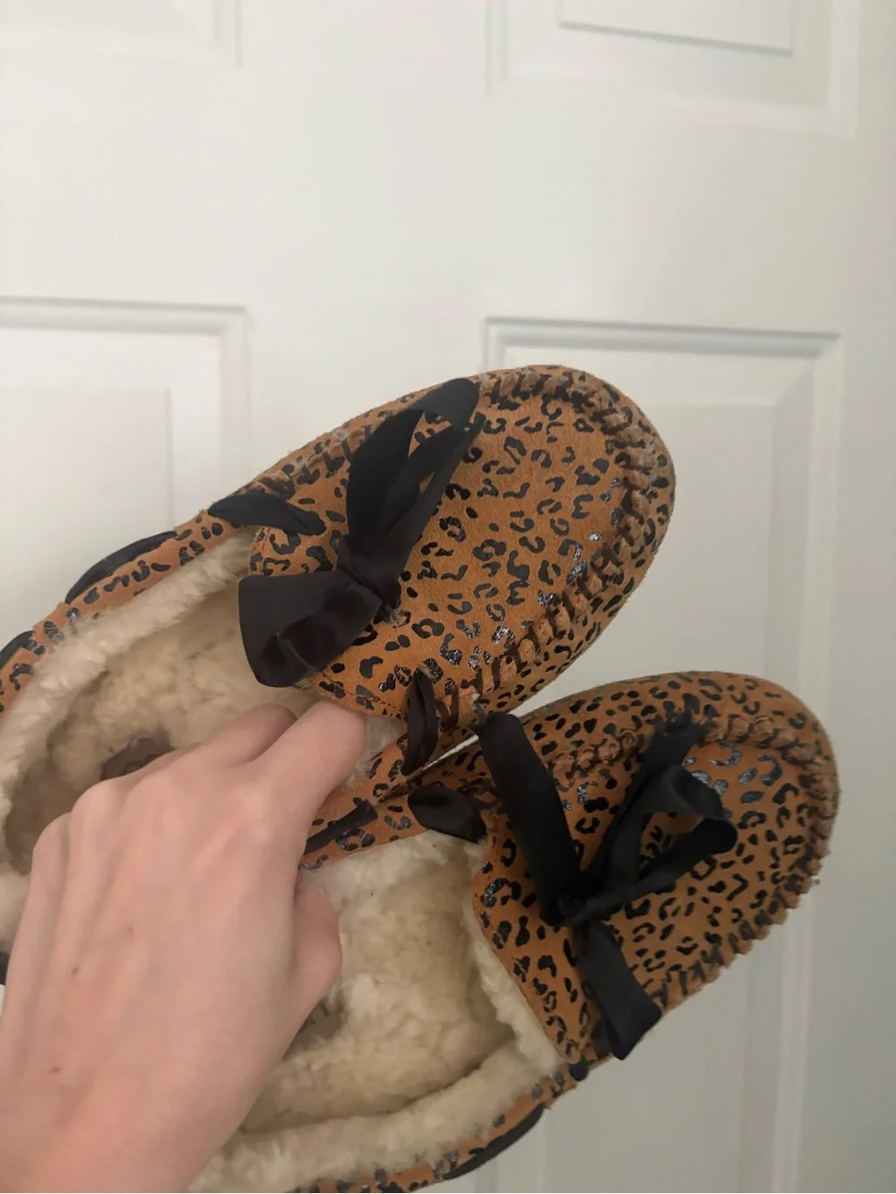 UGG women’s Leopard Print Faux-Fur Lined Slip-Ons in Brown and Black